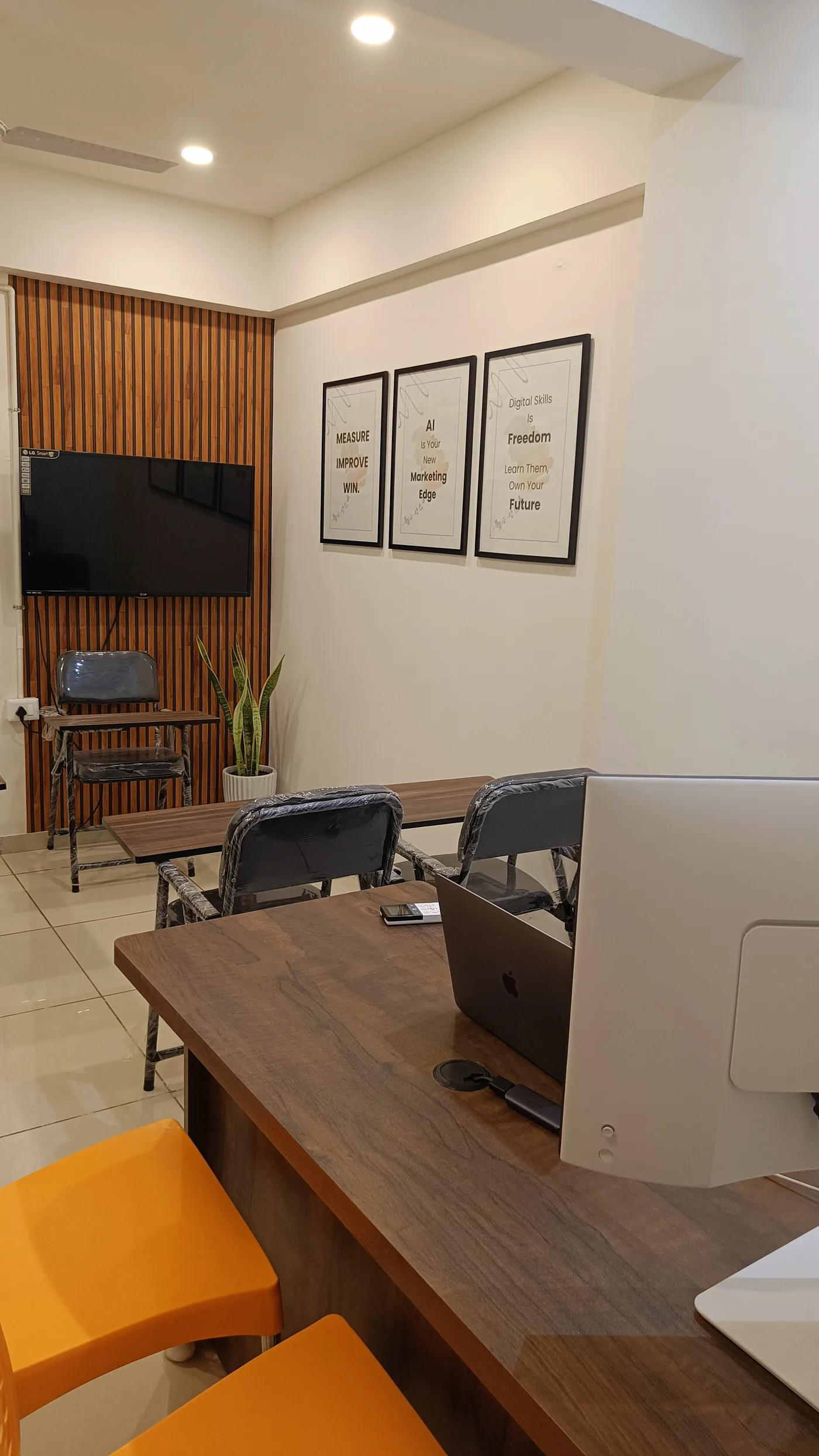 Small-batch seating at the Rizelex Academy studio with marketing posters on the wall